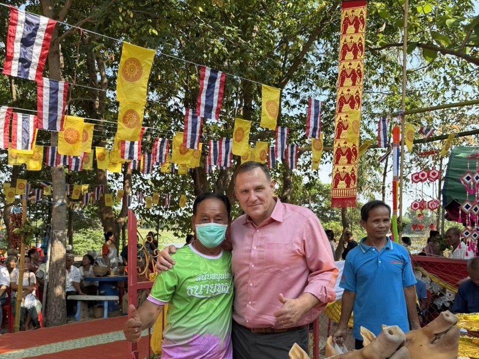 A village festival in Rattanaburi, Surin, with offerings and flags