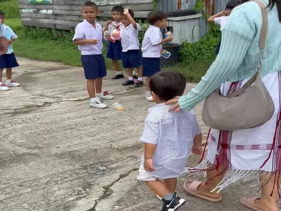 Children and an adult in the school yard